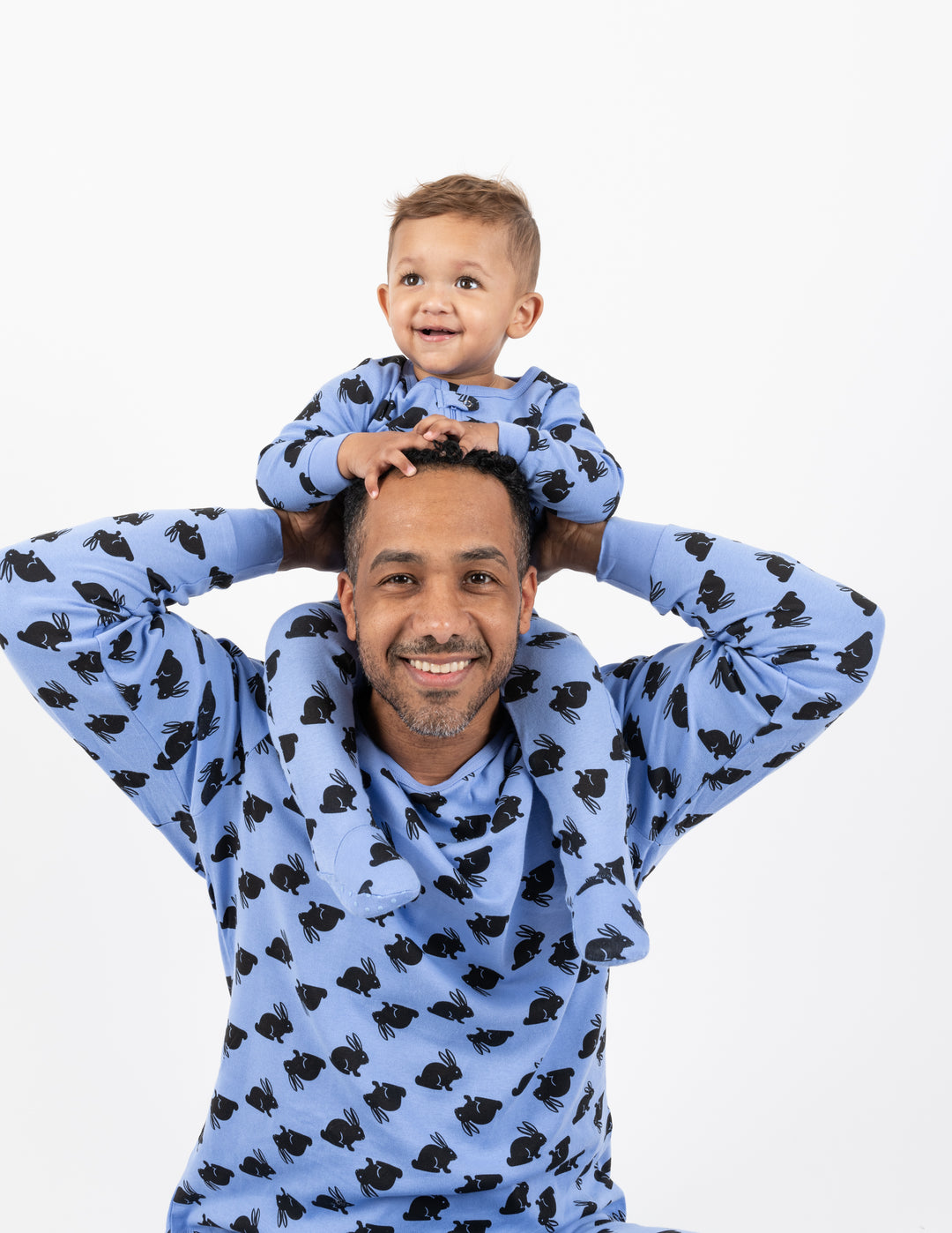 dad and baby wearing matching blue bunny pajamas