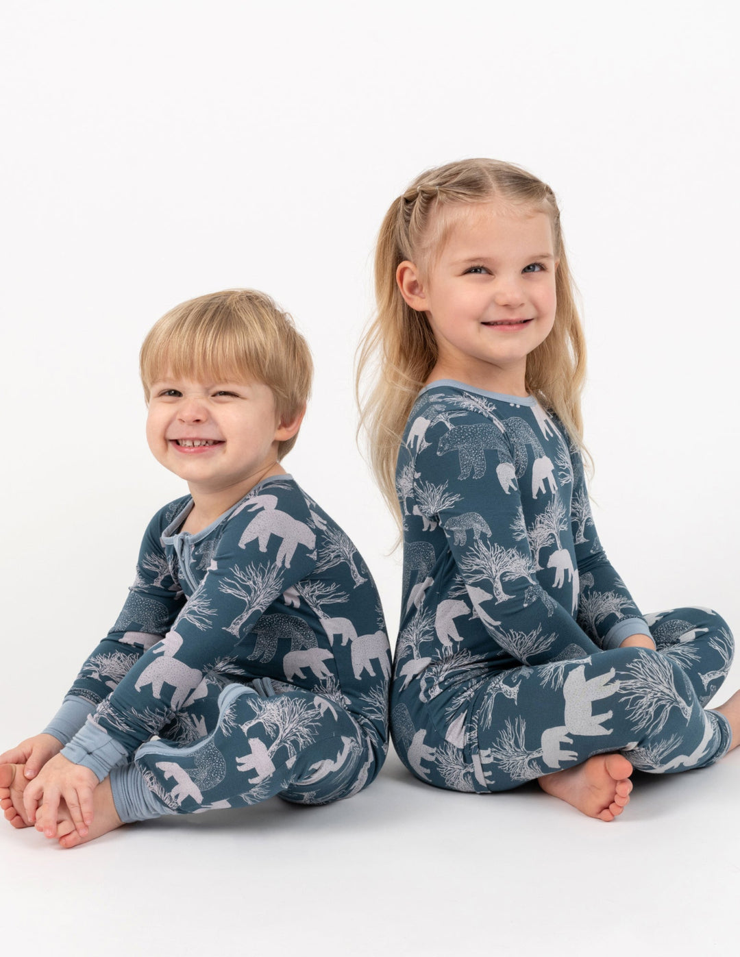 two children wearing blue polar bear pajamas