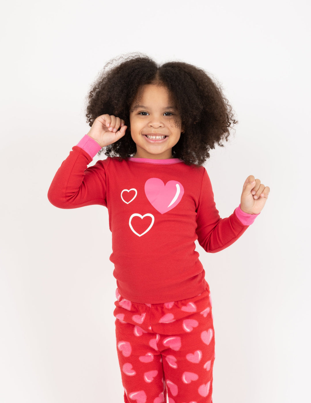 child wearing red heart fleece pajamas