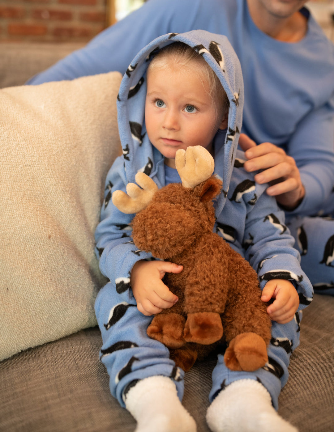 child in blue penguin fleece robe