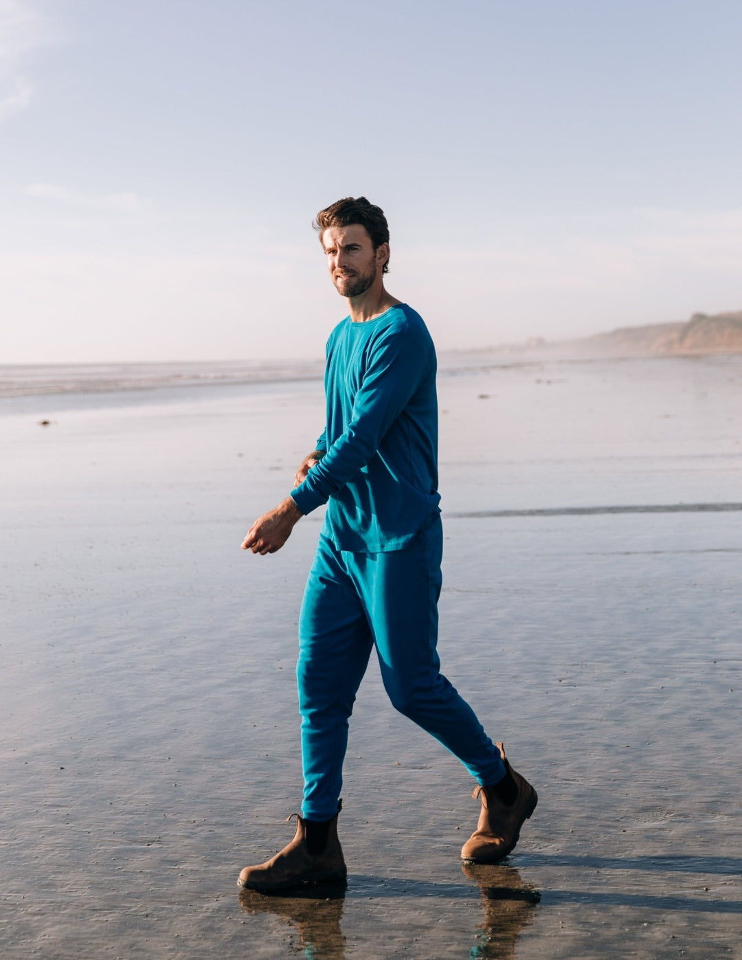 man walking on the beach wearing a pajama from Leveret