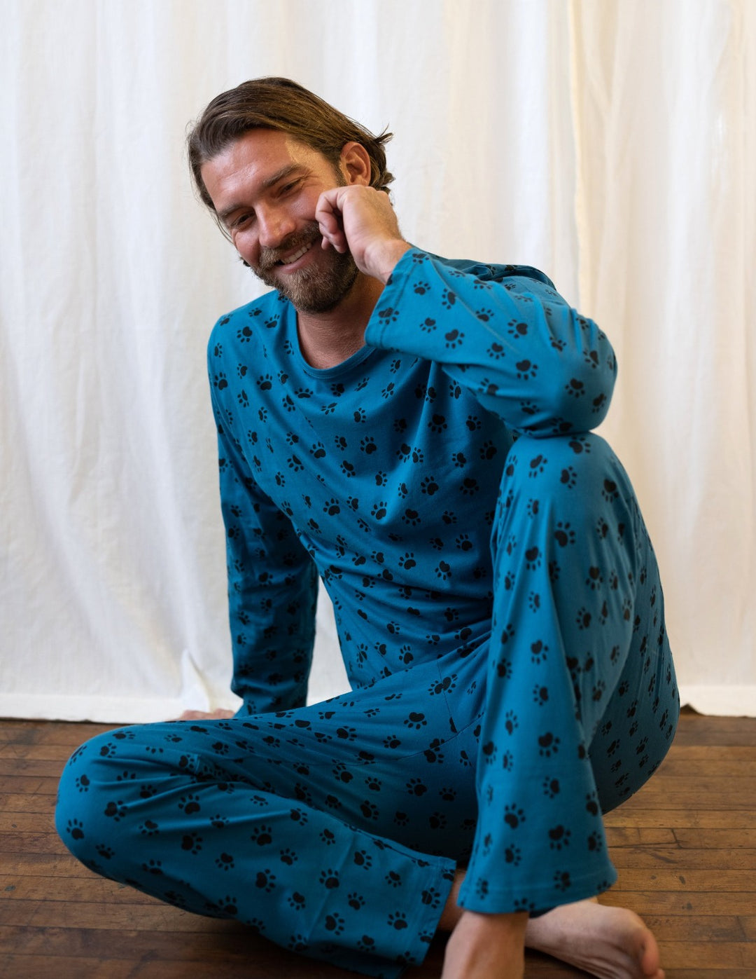 Man in a Leveret pajamas while sitting on the floor