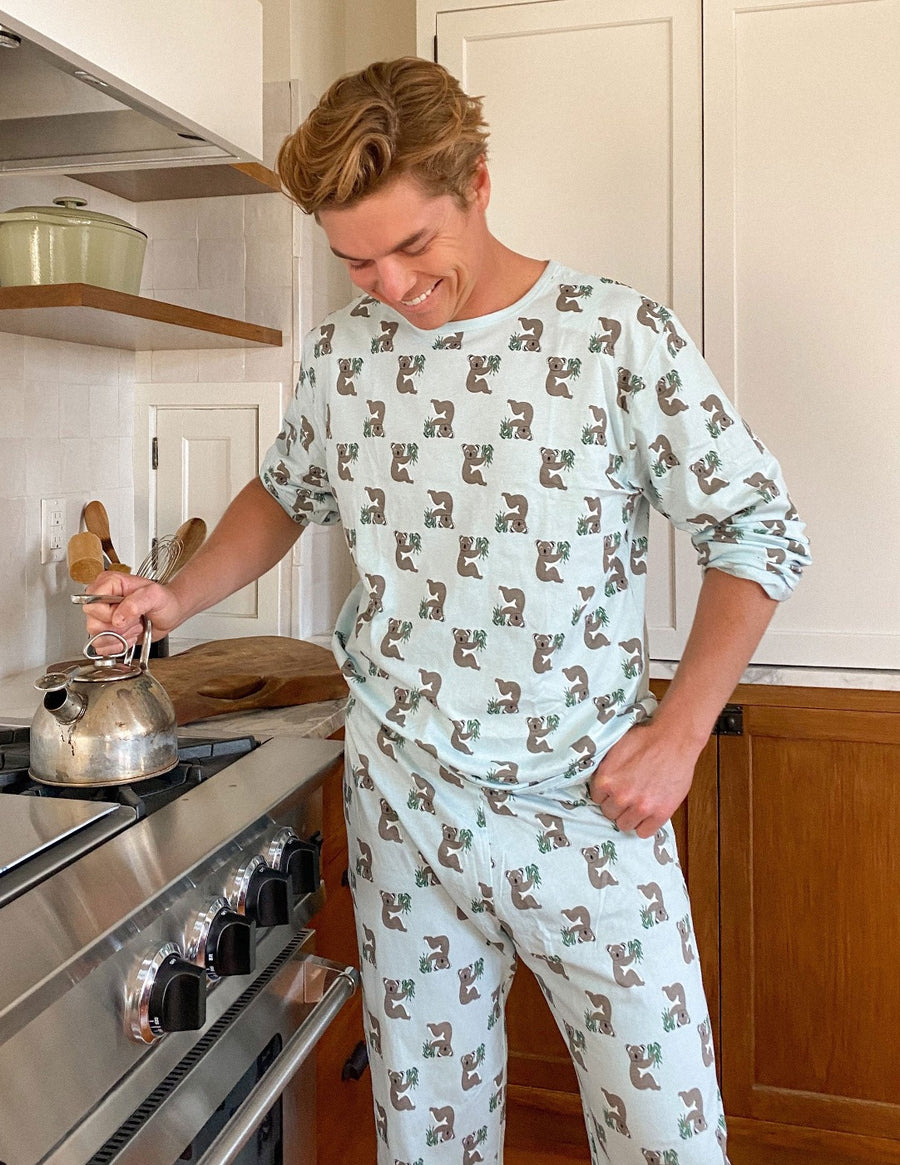 A man in Leveret's Loose Fit Animal Pajamas holding a kettle in the kitchen