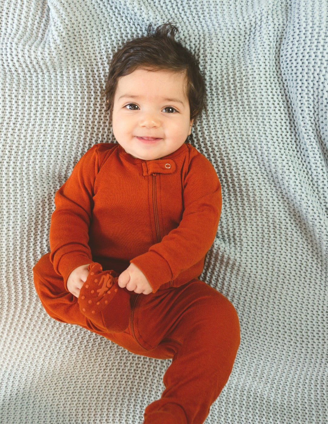 solid color rust orange baby footed pajamas